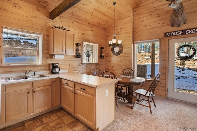 526 Wakanda Trl, Woodland Park, CO 80863 - kitchen featuring a sink, a peninsula, lofted ceiling with beams, wooden walls, and wood ceiling