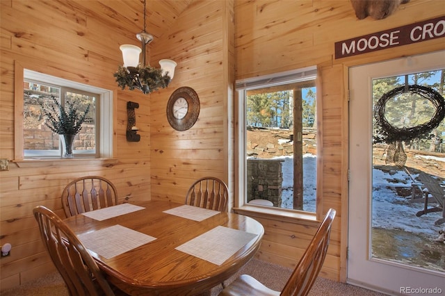 526 Wakanda Trl, Woodland Park, CO 80863 - dining space with wood walls and a notable chandelier
