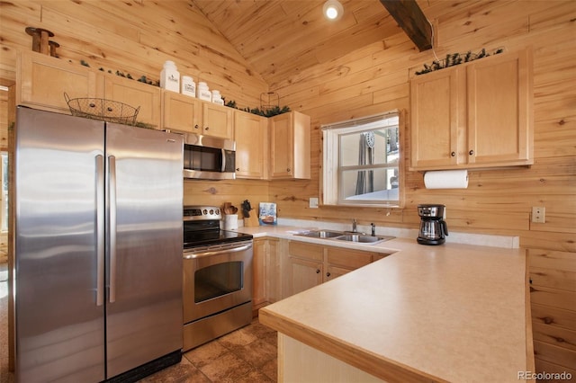 526 Wakanda Trl, Woodland Park, CO 80863 - kitchen with light brown cabinetry, appliances with stainless steel finishes, a sink, and vaulted ceiling