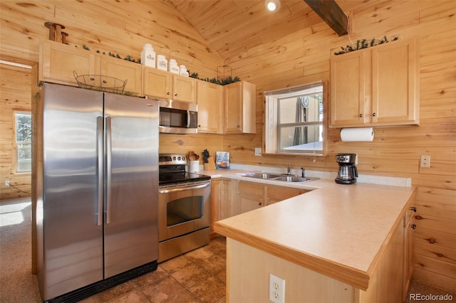 526 Wakanda Trl, Woodland Park, CO 80863 - kitchen with stainless steel appliances, lofted ceiling, light brown cabinets, and a sink