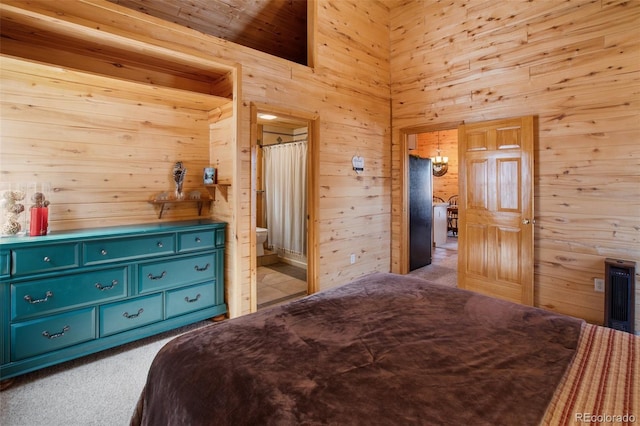 526 Wakanda Trl, Woodland Park, CO 80863 - bedroom featuring carpet flooring, wooden walls, ensuite bath, and a high ceiling