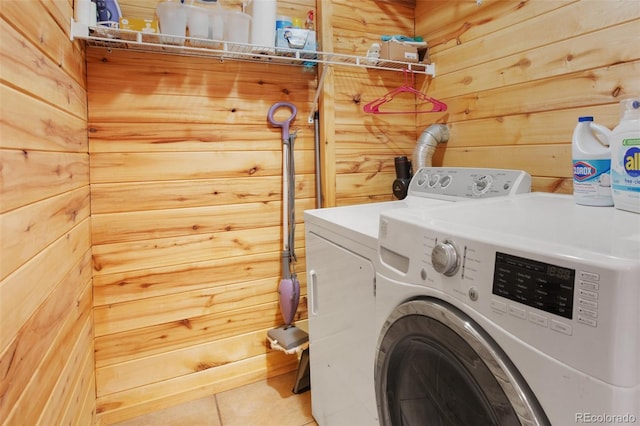 526 Wakanda Trl, Woodland Park, CO 80863 - washroom featuring tile patterned floors, laundry area, wood walls, and washing machine and clothes dryer