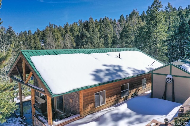 526 Wakanda Trl, Woodland Park, CO 80863 - rear view of house featuring a view of trees, metal roof, and a standing seam roof