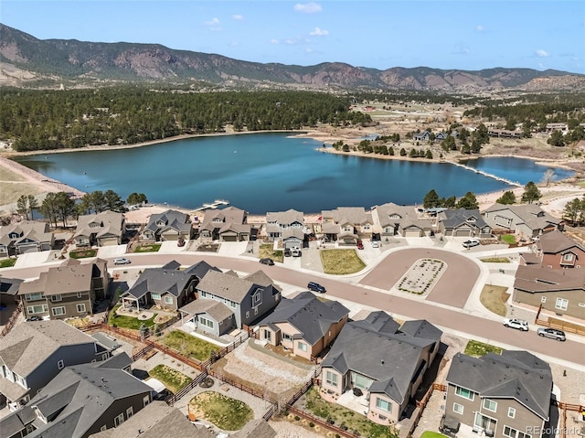 aerial view featuring a water and mountain view and a residential view