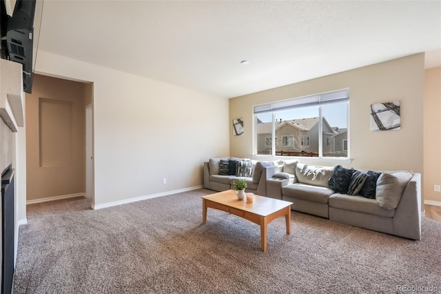 carpeted living area with baseboards