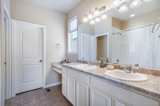bathroom with tile patterned floors, double vanity, a sink, and walk in shower