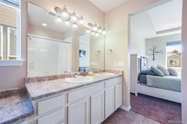 bathroom featuring a sink, visible vents, tile patterned floors, and ensuite bathroom