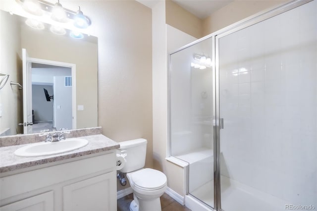 bathroom featuring visible vents, toilet, a shower stall, and vanity