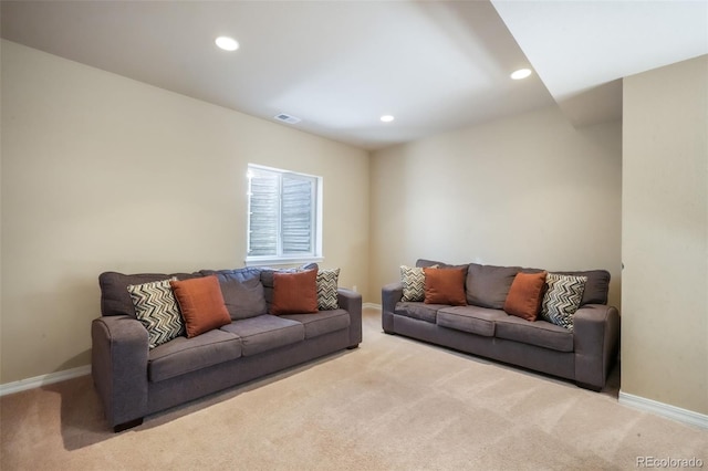 carpeted living area with recessed lighting, visible vents, and baseboards