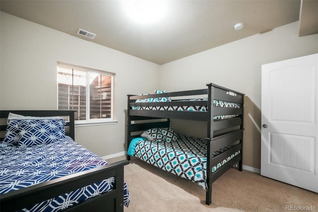 bedroom featuring baseboards, visible vents, and carpet floors