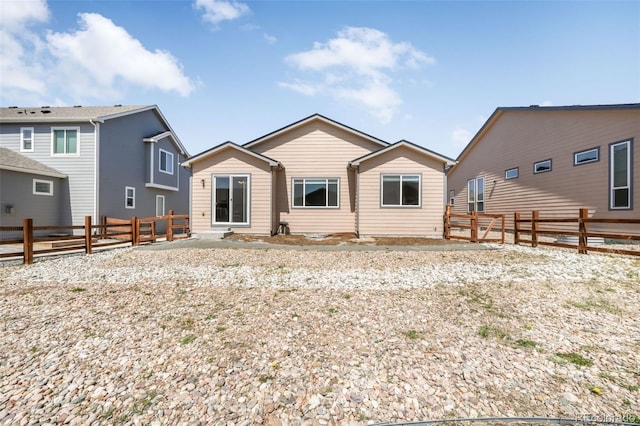 back of house with a fenced backyard