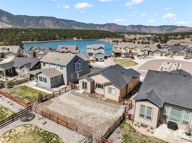 birds eye view of property with a residential view and a water and mountain view