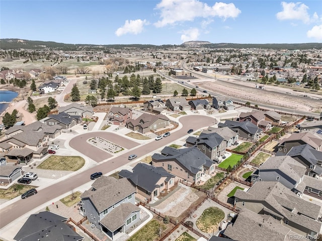 drone / aerial view featuring a water view and a residential view