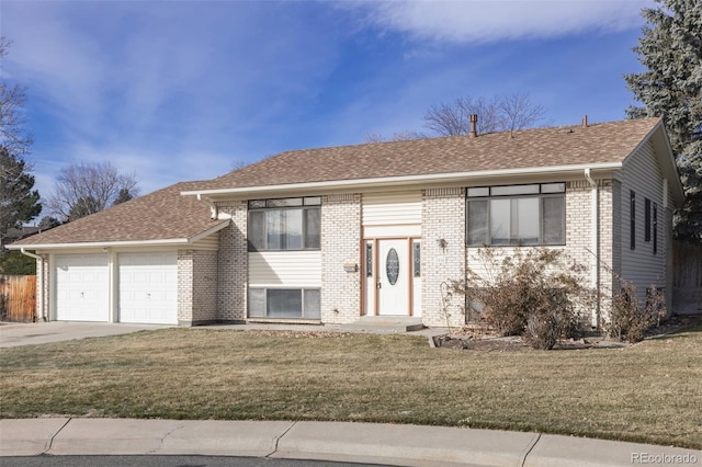 split foyer home with a garage and a front lawn