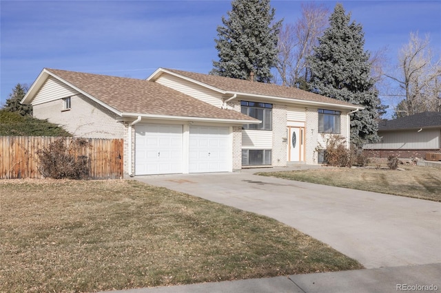 raised ranch with a garage and a front lawn