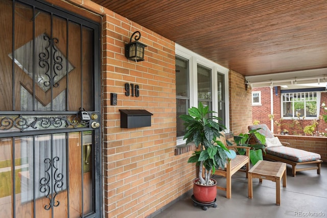 916 Adams St, Denver, CO 80206 - entrance to property featuring a porch and brick siding