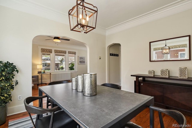916 Adams St, Denver, CO 80206 - dining area featuring arched walkways, crown molding, dark wood-style floors, ceiling fan, and baseboards