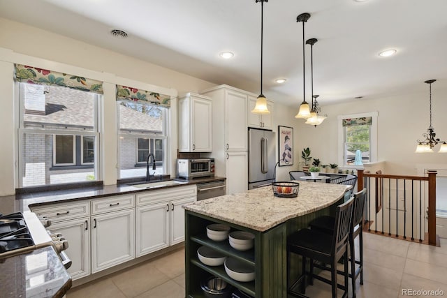 916 Adams St, Denver, CO 80206 - kitchen featuring appliances with stainless steel finishes, a sink, open shelves, light tile patterned flooring, and white cabinets