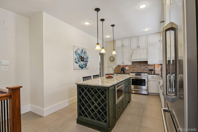 916 Adams St, Denver, CO 80206 - kitchen with appliances with stainless steel finishes, custom range hood, light tile patterned floors, white cabinets, and recessed lighting