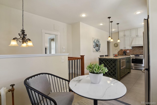 916 Adams St, Denver, CO 80206 - dining room featuring a chandelier, light tile patterned flooring, and recessed lighting