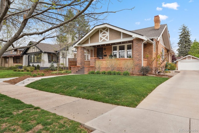 916 Adams St, Denver, CO 80206 - tudor home with brick siding, covered porch, an outbuilding, and a front yard