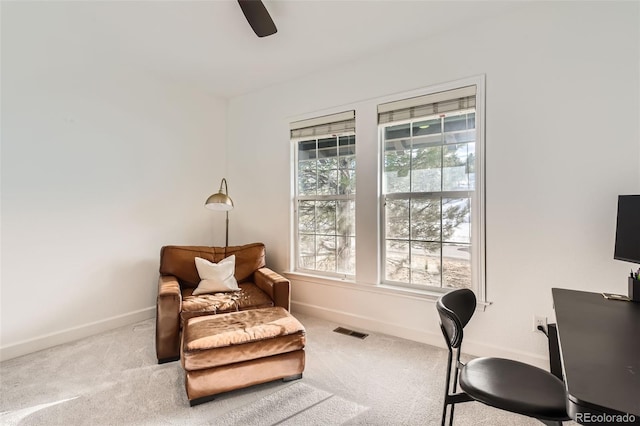 carpeted office with ceiling fan and plenty of natural light