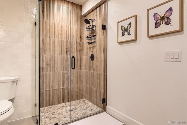 bathroom featuring walk in shower and toilet