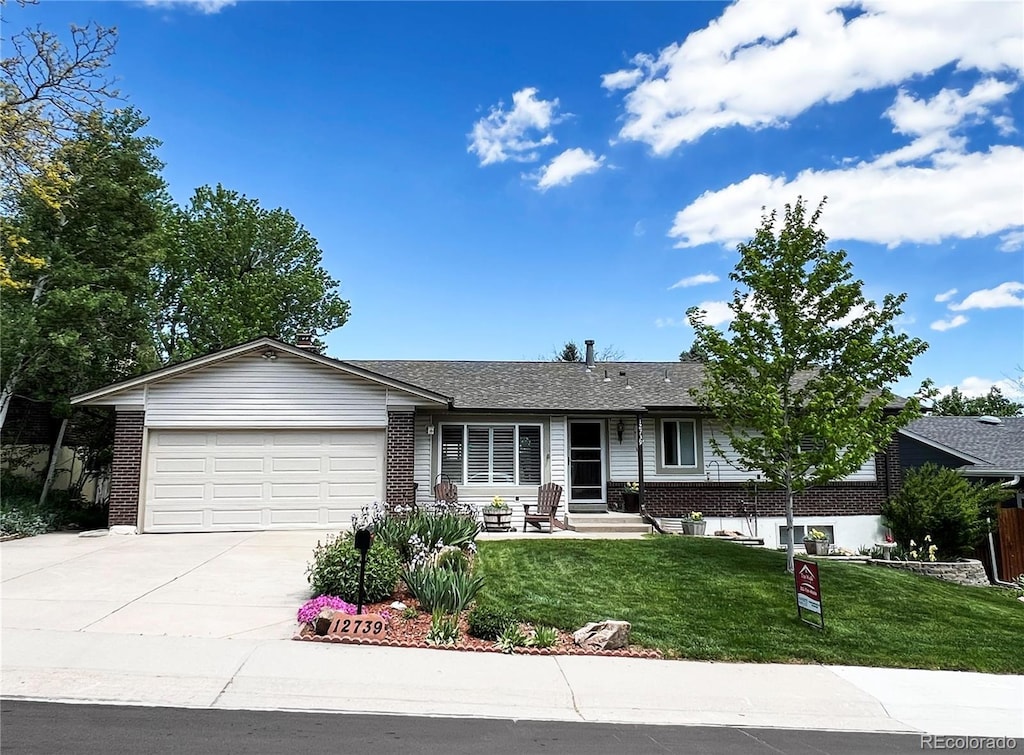 12739 W Alabama Pl, Lakewood, CO 80228 - ranch-style home featuring brick siding, an attached garage, driveway, and a front lawn