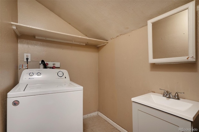 laundry room featuring light tile patterned floors, laundry area, a sink, baseboards, and washer / clothes dryer