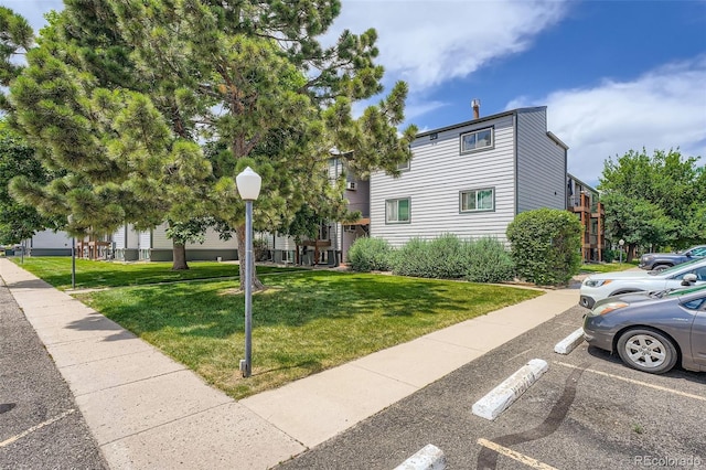 16259 W 10th Ave Unit K1, Golden, CO 80401 - view of side of home featuring uncovered parking and a lawn