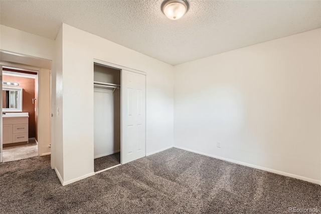 16259 W 10th Ave Unit K1, Golden, CO 80401 - unfurnished bedroom with carpet flooring, a textured ceiling, and a closet