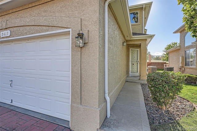 2417 S Racine Way, Aurora, CO 80014 - entrance to property with stucco siding and a garage