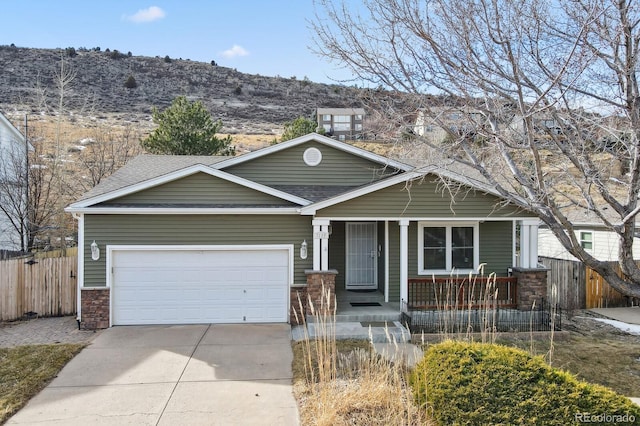 craftsman house featuring a garage, a mountain view, and covered porch