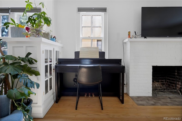 misc room with a fireplace and hardwood / wood-style floors