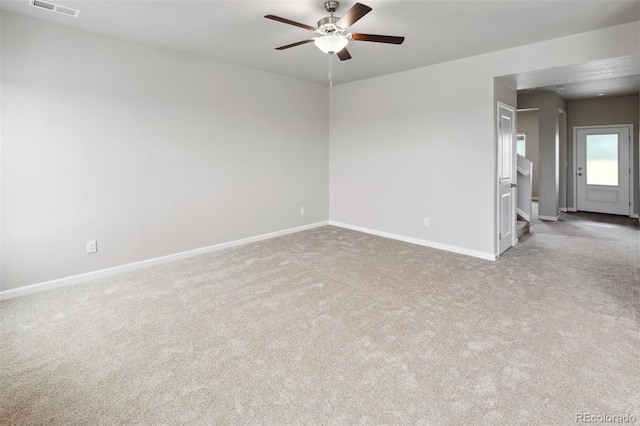 empty room with light colored carpet and ceiling fan