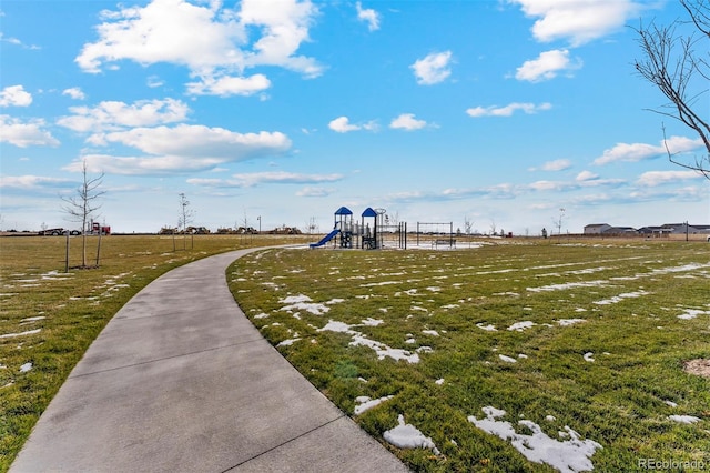 view of property's community featuring a yard and a playground