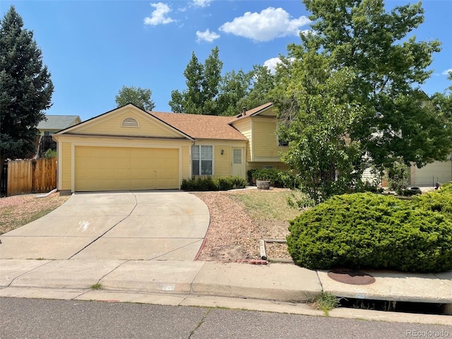 5745 S Quatar Ct, Centennial, CO 80015 - tri-level home featuring driveway and an attached garage
