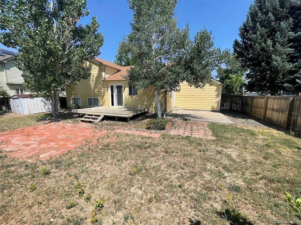 5745 S Quatar Ct, Centennial, CO 80015 - back of property featuring a wooden deck and a patio area