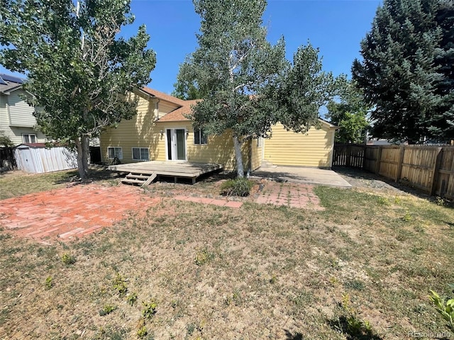 5745 S Quatar Ct, Centennial, CO 80015 - back of property featuring a wooden deck and a patio area
