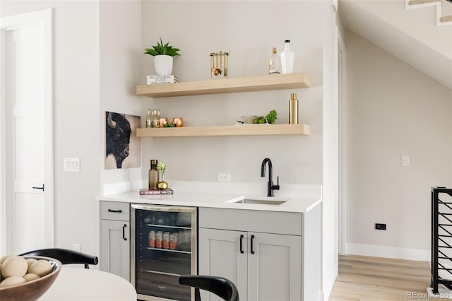8280 E 36th Ave Unit 26, Denver, CO 80238 - indoor wet bar with wine cooler, light wood-type flooring, and baseboards