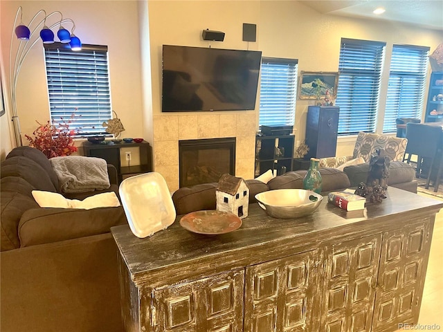 living room with a wealth of natural light and a tile fireplace