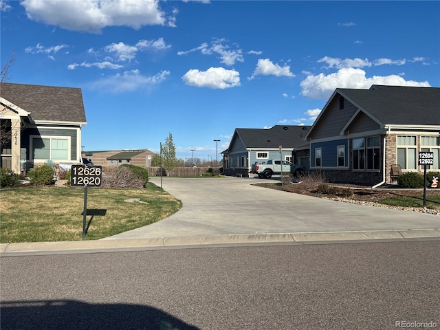 view of side of property featuring a lawn and driveway