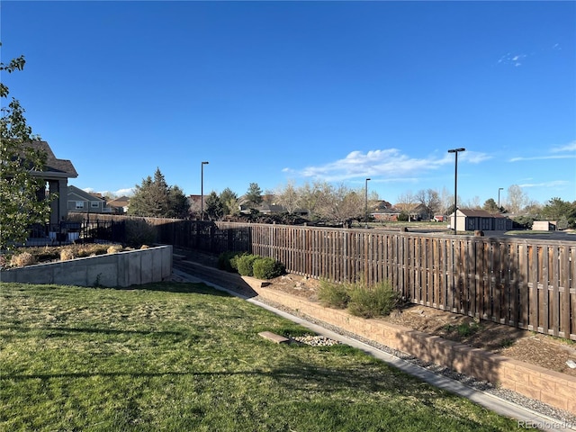view of yard with a fenced backyard