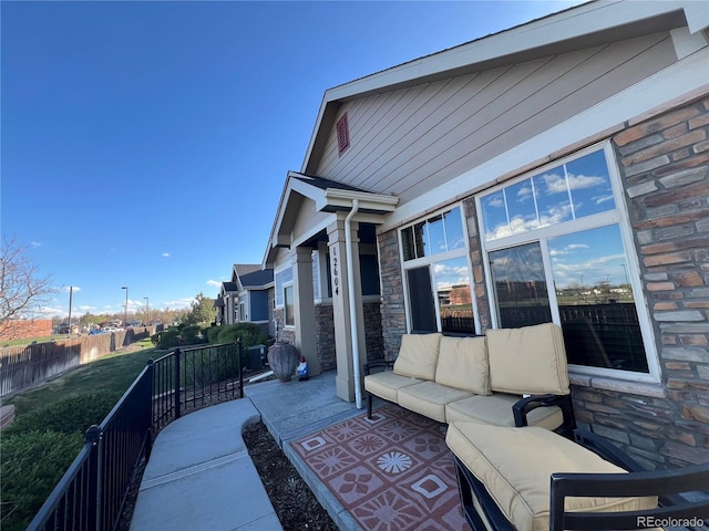 view of patio featuring an outdoor hangout area and fence