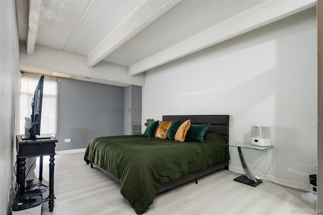 675 S University Blvd Unit 106, Denver, CO 80209 - bedroom featuring beam ceiling, light wood finished floors, and baseboards