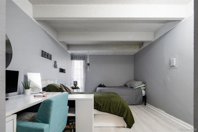 675 S University Blvd Unit 106, Denver, CO 80209 - bedroom with light wood finished floors, beam ceiling, and baseboards