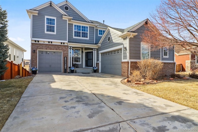 craftsman inspired home with brick siding, concrete driveway, a front yard, and fence