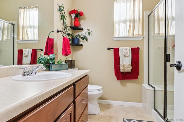 bathroom with a stall shower, baseboards, toilet, tile patterned floors, and vanity