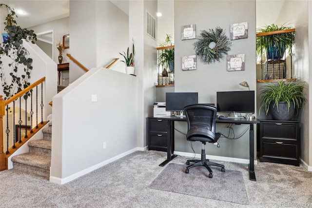 office space with baseboards, visible vents, and light colored carpet