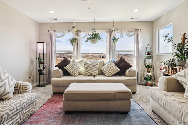 living area featuring recessed lighting, dark carpet, visible vents, and baseboards